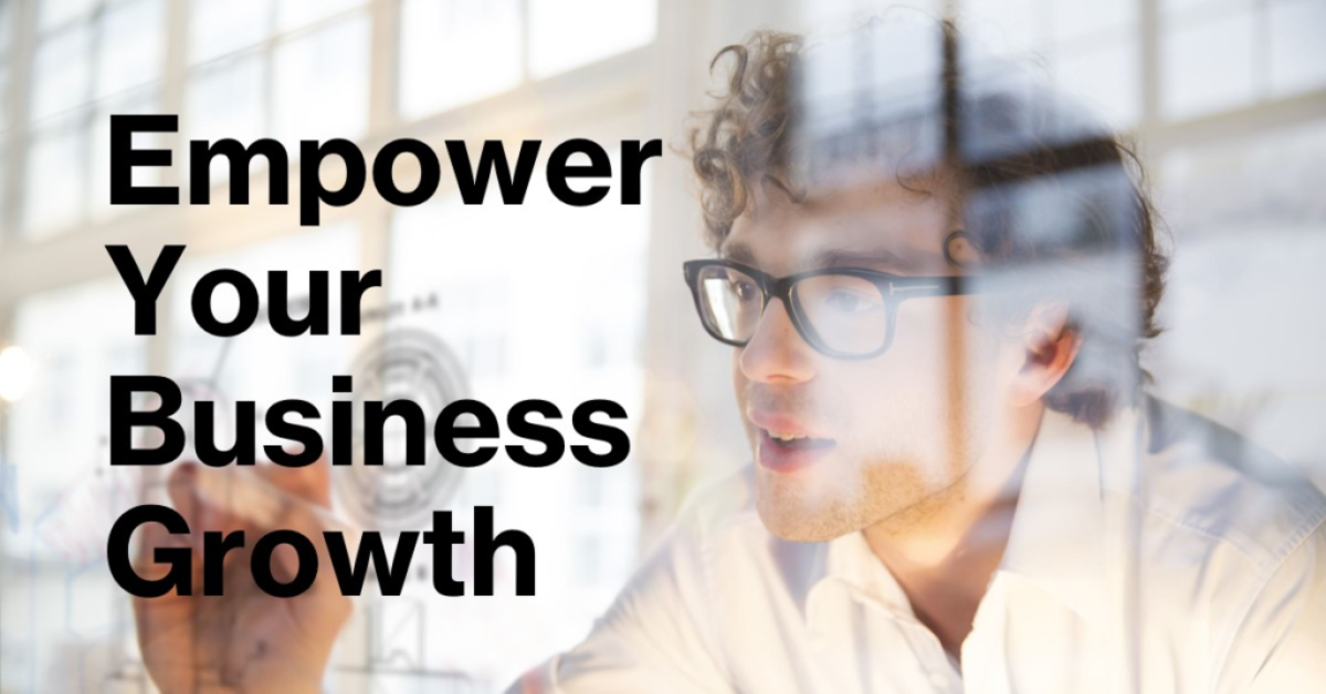 A promotional image featuring a blurred individual in the foreground with glasses and curly hair, looking towards text that reads “Empower Your Business Growth” in bold, black font on a translucent overlay.